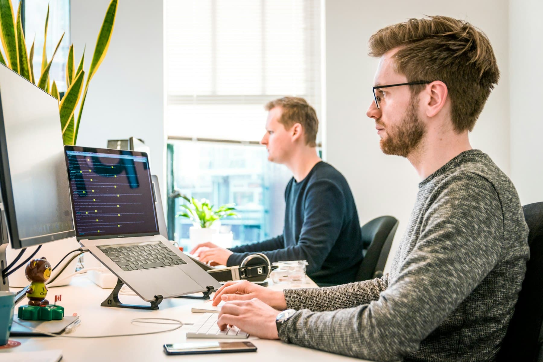 Engineers working through a release on adjacent screens.